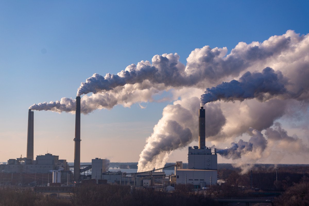 Industrial smokestacks producing smoke